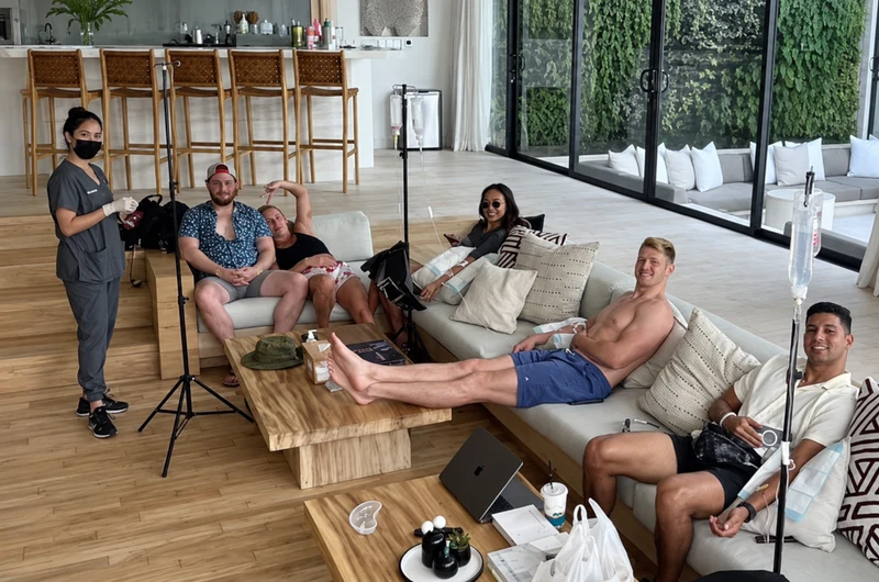 An IV DRIP BALI villa visit, with the masked nurse visible at the left of the group